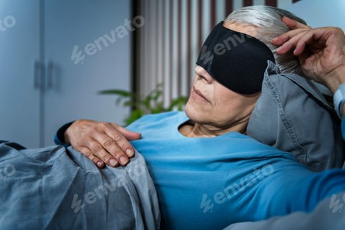 Preview: Mature Woman Wearing Black Sleep Mask, Lying in Bed