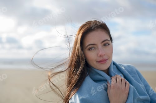 Preview: Young woman wrapped in blanket