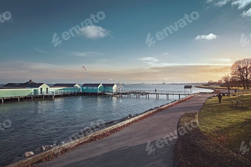 Preview: Serene coastal view at sunset with a wooden pier