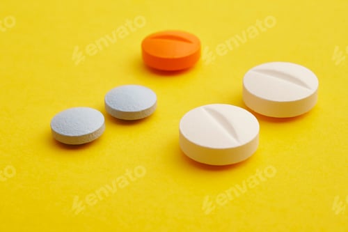 Preview: Pills over a yellow background. Medicament treatment. Health care photo