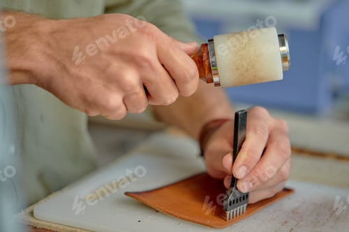 Preview: guy Punching Holes in Leather for Stitching