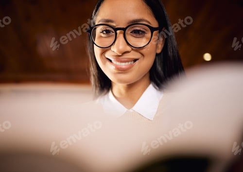 Preview: I get to study what I like. Shot of a female student wearing glasses while reading at home.