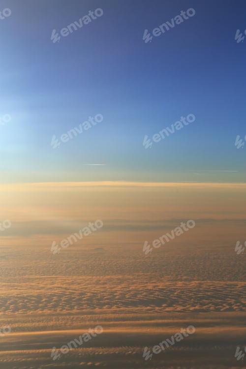 Preview: Blue sky over the surface of orange clouds, aerial photography