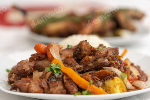 Preview: Plate of stew of guinea pig meat on a table