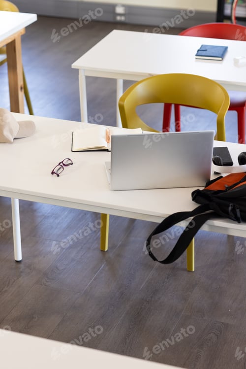 Preview: Laptop, notebook, and glasses on school desk, ready for studying or working