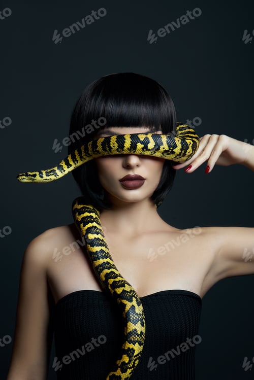 Preview: Beauty woman short haircut python yellow snake on her neck. A yellow snake on the shoulders