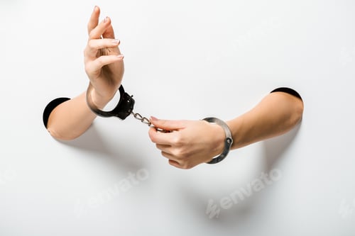 Preview: cropped image of woman in handcuffs holding hands through holes on white
