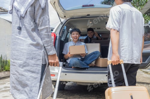 Preview: Muslim Men Loading Moving Boxes and Suitcases into Car Trunk During Homecoming Preparation