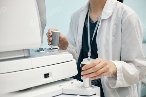 Preview: Young Doctor in White Coat Operating Ophthalmology Equipment