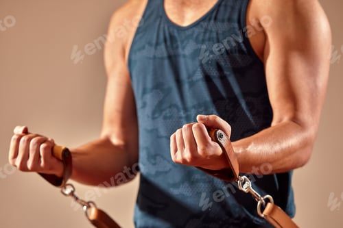 Preview: An athletic man does an exercise on a reformer in the gym. No face. Feet close-up on the reformer