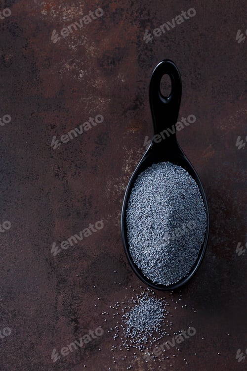 Preview: Spoon of poppy seed on rusty metal
