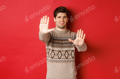 Preview: Image of disappointed handsome man, asking to stop, rejecting something awful, standing displeased