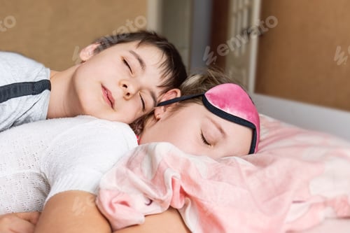 Preview: Brother and sister sleep sweetly, hugging.