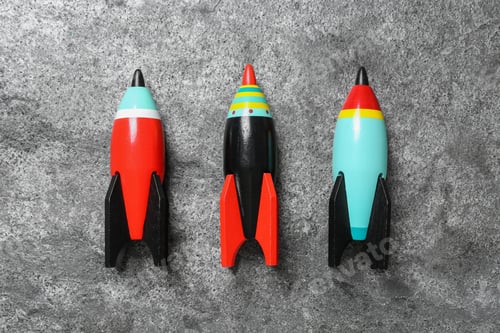 Preview: Bright color wooden rockets on grey background, flat lay
