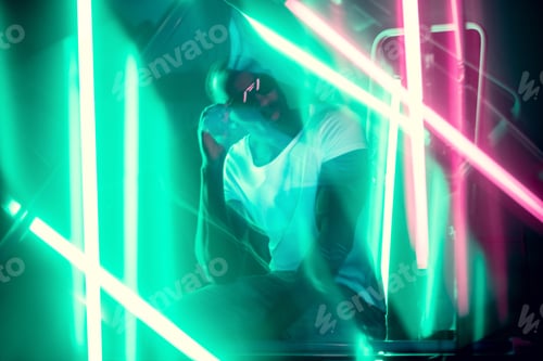 Preview: Cinematic portrait of handsome young man in neon lighted room, stylish musician