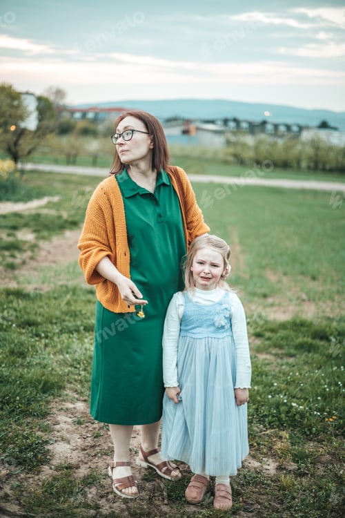 Preview: mother comforts the crying of a little daughter, a walk in nature, children's emotions, motherhood