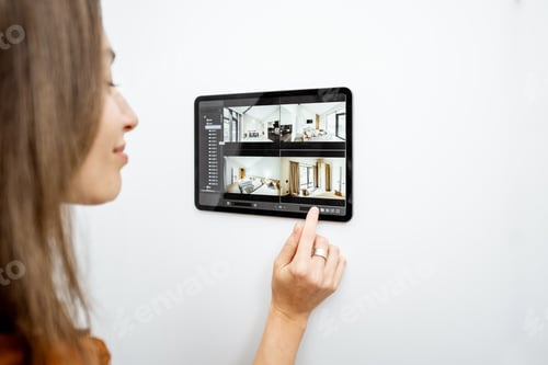 Preview: Woman controlling home with video cameras and digital tablet