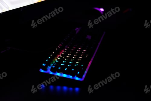 Preview: Close-up of a keyboard in neon rainbow color