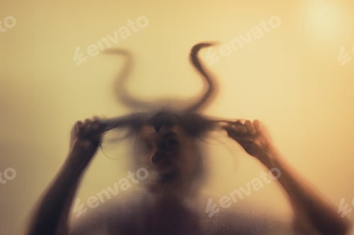Preview: Horror, halloween background - Shadowy figure with horns behind the glass
