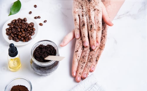 Preview: Spa concept. A young woman does a hand massage with a homemade coffee scrub