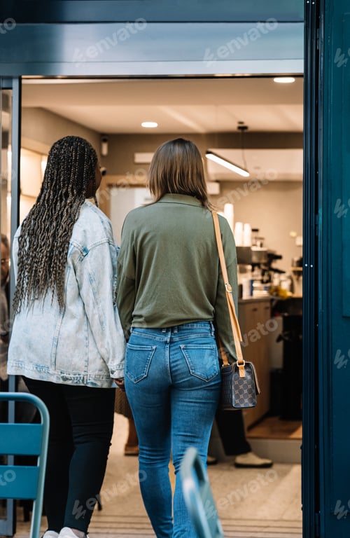 Preview: Multiethnic lesbian couple walking into a cafe