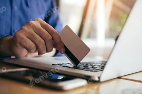 Preview: Man using credit card with shopping online concept at cafe.
