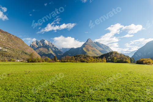 Preview: Vibrant green meadow and high Alps in Slovenia