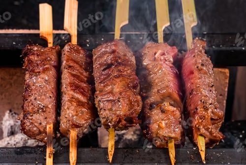 Preview: Beef Shish Kebab, stripes sliced meat cooking with flame. Homemade shashlik cooking or restaurant, m