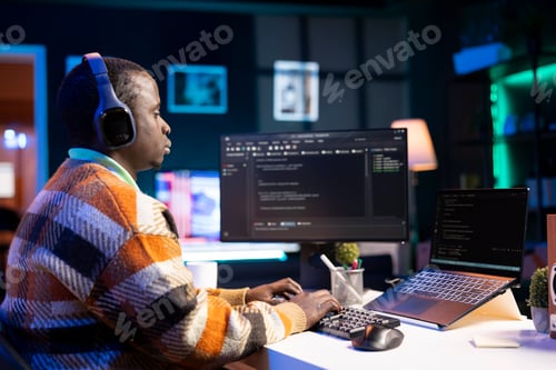Preview: Black software engineer writes complex binary code scripts on computer
