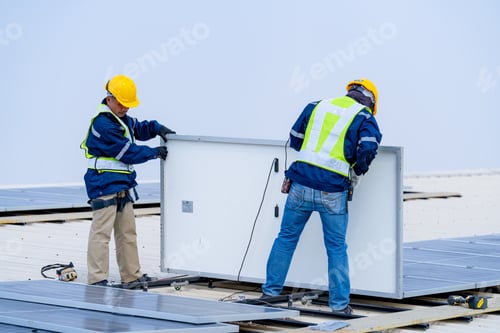 Preview: workers installing solar panels, for efficient energy on rooftop