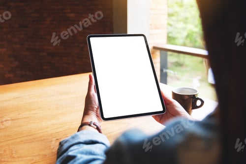 Preview: Mockup image of a woman holding digital tablet with blank white desktop screen in cafe