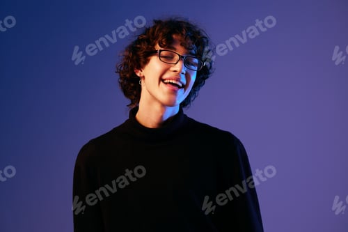 Preview: Man fashion portrait in black clothes model poses in close-up glasses, curly hair, hipster lifestyle