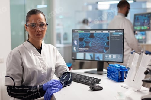 Preview: Laboratory doctor looking at camera smiling in modern equipped lab