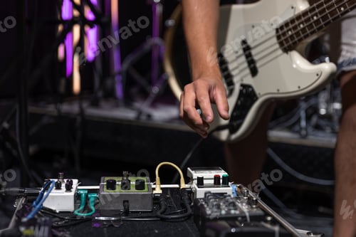 Preview: Close-up set of distortion effect pedals for guitar on stage.
