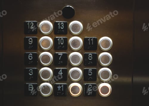 Preview: Silver circle buttons in an elevator with thirteen floors and a basement