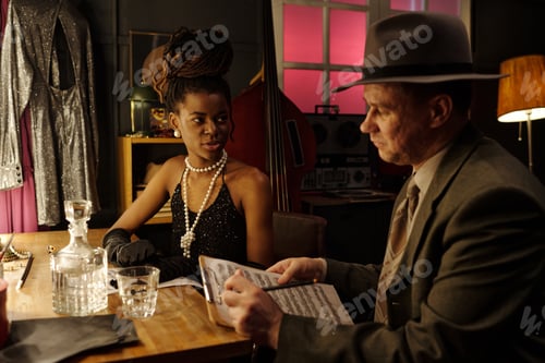 Preview: Young Black Woman and Middle Aged Caucasian Man Discussing Jazz Sheet Music