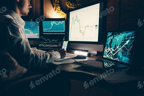 Preview: Male trader analyzing stock market data while sitting at the office workstation