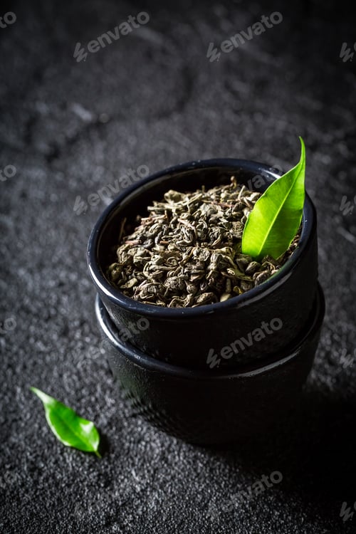 Preview: Closeup of green tea in a teacup on black background