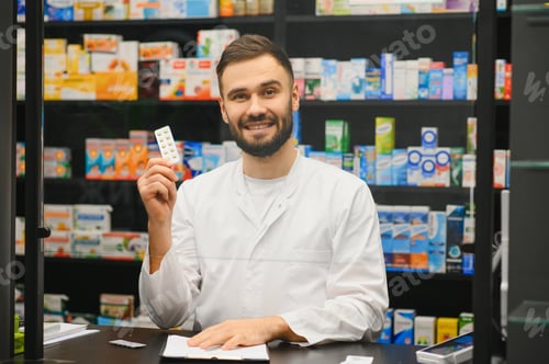 Preview: Pharmacist holding blister pack of pills in pharmacy