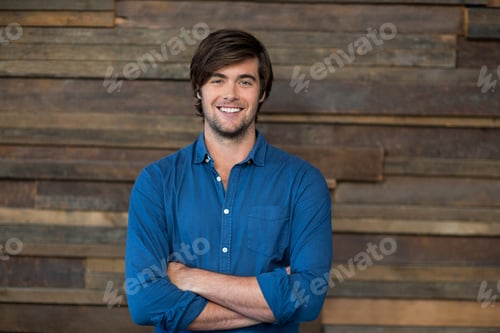 Preview: Portrait of male business executive standing with arms crossed