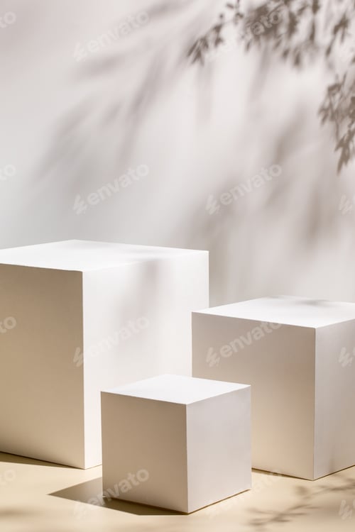 Preview: empty stage with three white rectangle podiums on beige background and shadows of tree leaves