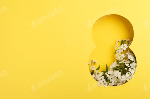 Preview: 8 March greeting card. Paper cut Eight made of yellow background and fresh spring flowers bouquet of