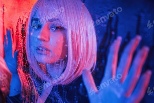 Preview: Front view. Stylish woman with white hair is behind wet transparent plastic sheet