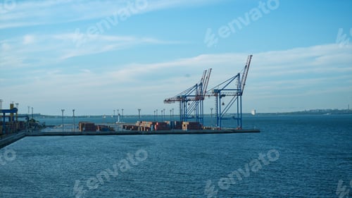 Preview: Industrial seaport cranes view in still morning waterway. Logistic facility dock