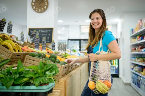 Preview: Cheerful woman choosing products in supermarket