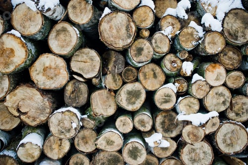 Preview: Stack of wood chunks covered with snow. Winter.