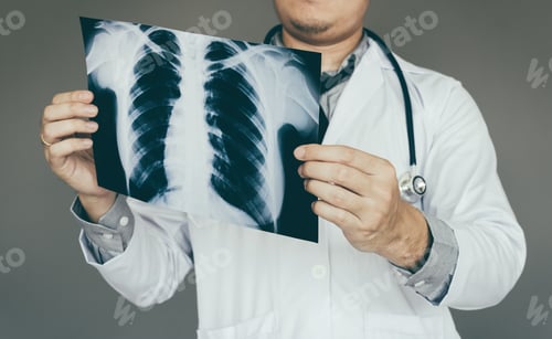 Preview: confident doctor man holding x-ray film in lab room.