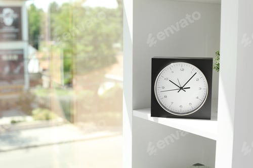 Preview: Analog clock on shelf indoors. Time of day