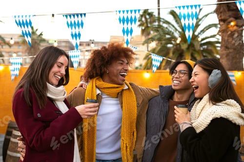 Preview: friends enjoying coffee outdoors on winter day. College students outside drinking hot chocolate