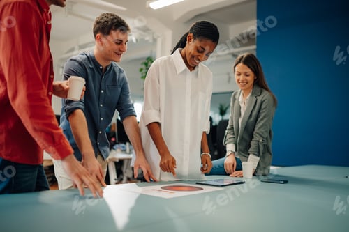 Preview: Marketing team analyzing charts and reports in modern office